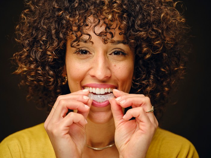 Young girl following guide by Biltmore Dental Center to maintain clear aligners in Phoenix, AZ